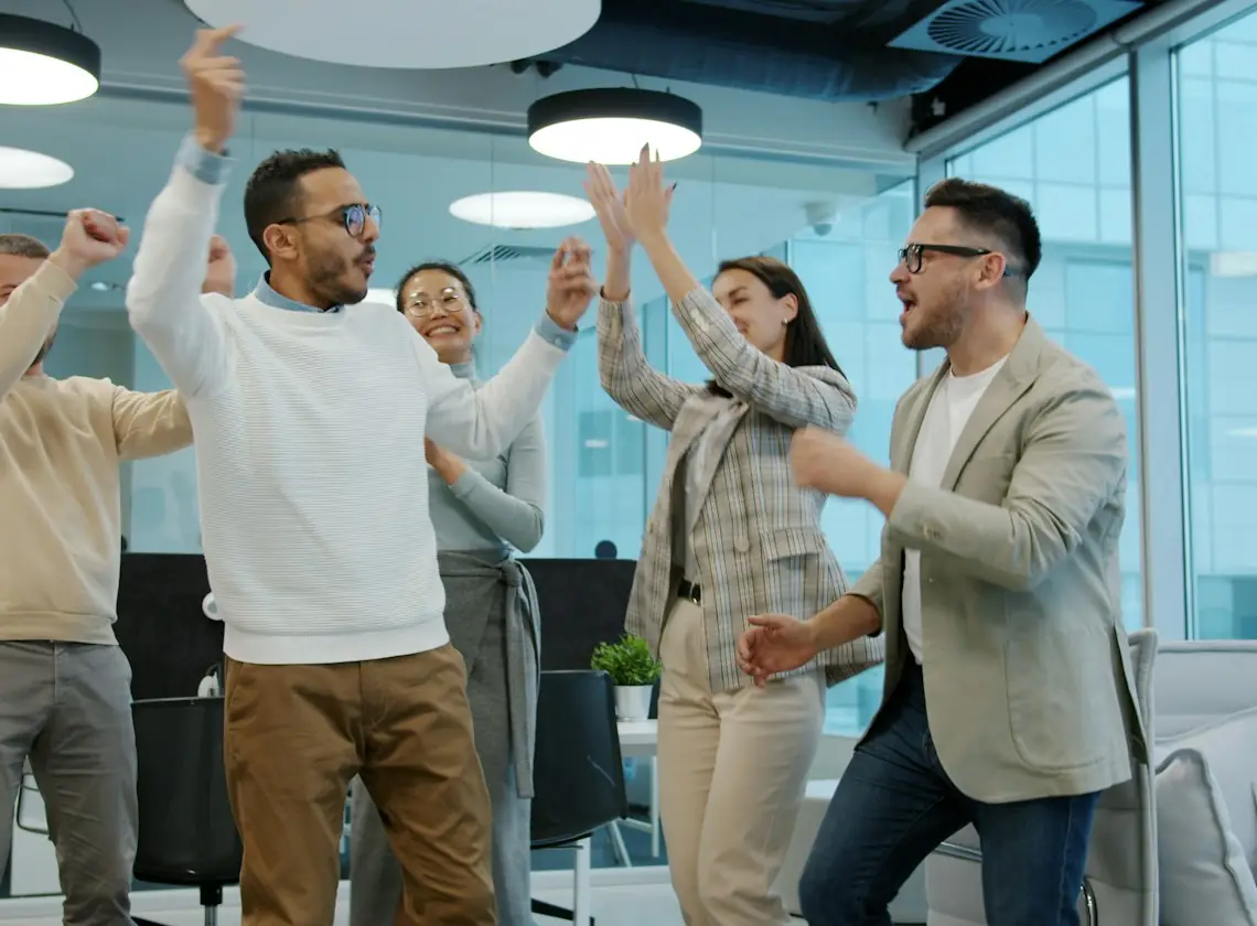 Colleagues celebrating a project launch in an office